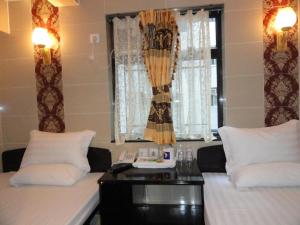 Postelja oz. postelje v sobi nastanitve First Inn Hotel & Guest House Reception at 10TH F, Block E