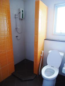 a bathroom with a toilet and a shower at The Porch ABAC Bangna in Samutprakarn