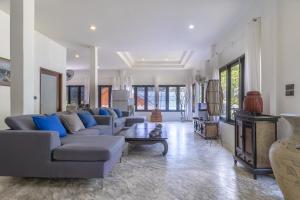 a large living room with couches and a tv at Aloe Villa in Koh Tao
