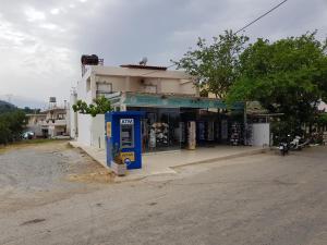 a blue phone booth on the side of a street at Mikes Apartment in Georgioupolis