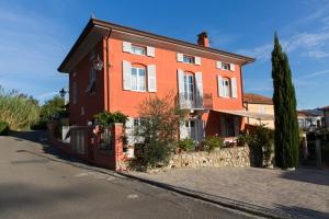 a large orange house on the side of a street at Villa I Poggioli in Bocca di Magra