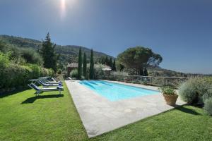 a swimming pool in a yard with two lounge chairs at Villa la Certosa in Cortona