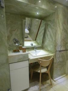 a bathroom with a sink and a toilet and a mirror at Eco Suites Caves in La Laguna +41 photos