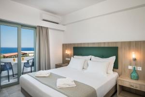 a bedroom with a bed with a view of the ocean at Glykeria Hotel in Elafonisi