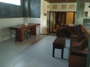 a room with a table and chairs and a dining room at Made House Homestay and Dormitory in Sanur