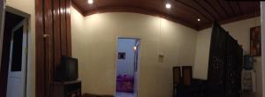 a room with a hallway with a television and a door at Bromo Deddy Homestay in Bromo