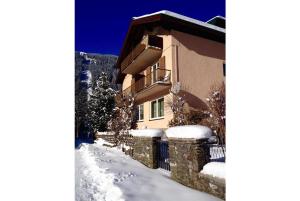 a building with snow on the side of it at Pension Charlotte in Bad Gastein