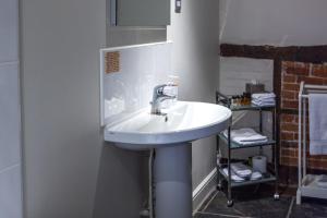 a bathroom with a white sink in a room at The Old Vine in Winchester