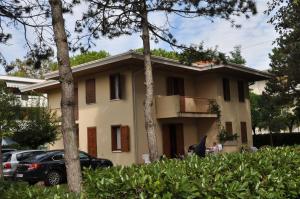 een huis met een auto ervoor geparkeerd bij Ville Carla e Caterina in Bibione