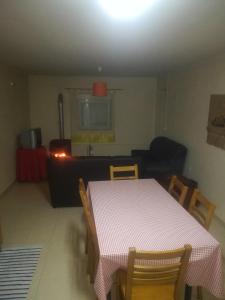 a living room with a table and chairs and a couch at Casa Nogueira in Travancinha