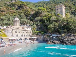 a group of people on a beach near the water at The italian riviera in San Salvatore