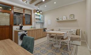 a kitchen and dining room with a table and chairs at Divona Studio 2 in Ruse