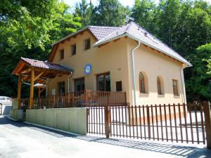 a small building with a fence in front of it at Penzion Pod Kartouzkou in Dolany