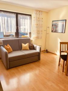 a living room with a couch and a table at Haus Alpenrose in Trins