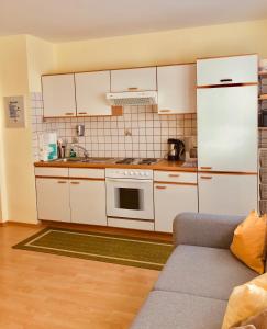 a kitchen with white cabinets and a white refrigerator at Haus Alpenrose in Trins