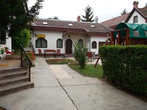 a house with a porch and stairs to a yard at Hotel Palota in Budapest