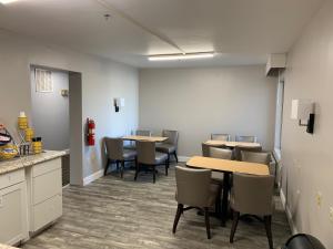 a waiting room with tables and chairs in an office at Days Inn by Wyndham Thomson in Thomson
