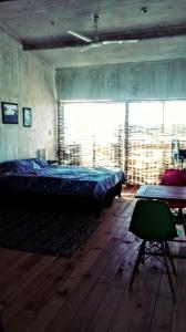 a bedroom with a bed and a table and a window at Arachania al Mar II in Costa Azul