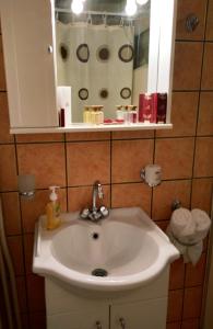 a white sink in a bathroom with a mirror at Xista Manor House ® in Pyrgi