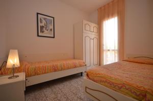 En eller flere senge i et værelse på Villaggio Michelangelo - Lemene