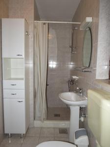 a bathroom with a shower and a toilet and a sink at Apartments Lumbarda in Lumbarda +37 photos