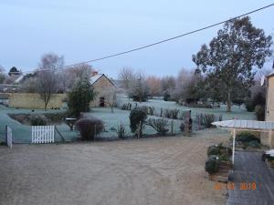 a view of a yard with snow on the ground at La ferme aux chats in Formigny