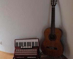 a guitar and a keyboard next to a wall at BodenSEE Apartment "La Musica" in Meckenbeuren