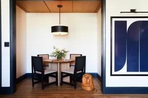 a dining room with a table and chairs at Shinola Hotel in Detroit