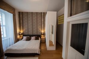 a bedroom with two beds and a large window at Király Str Apartman with free parking in Pécs