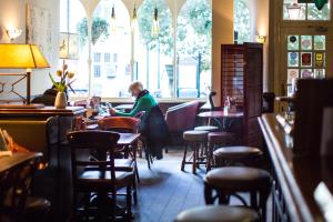 a woman sitting at a table in a restaurant at The Old Vine in Winchester