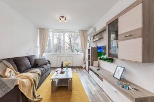 a living room with a couch and a table at Ada Bucharest Apartment in Bucharest