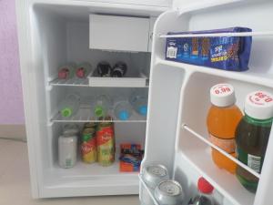 an open refrigerator filled with drinks and drinks at Hotel Farrapos in Porto Alegre