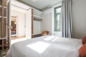 a bedroom with a white bed and a window at Nest in Athens