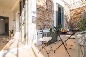 a patio with a table and chairs on a balcony at Nest in Athens