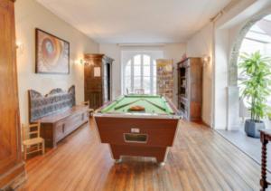 a large room with a pool table in it at Hotel D'Angleterre in Roscoff