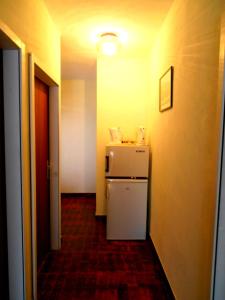 a hallway with a white refrigerator in a room at Pansion Danijela in Rogoznica +38 photos