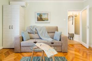 a living room with a couch and two tables at Central stylish & cozy one bedroom Apartment - Adela Accommodation - Ideal for long stays in Bucharest