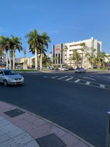 a street with cars parked on the side of the road at taniyumbo in San Bartolomé