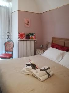 sypialnia z łóżkiem z dwoma ręcznikami w obiekcie Sweet Sweet Home w mieście Tolve