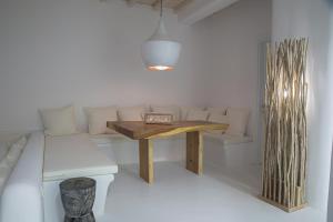 a table in a room with a couch and a table and a bench at VILLA ATHENA- Private Pool- Amazing Aegean View in Fanari