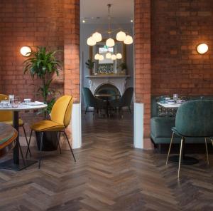 a restaurant with tables and chairs and a fireplace at The Wilder in Dublin
