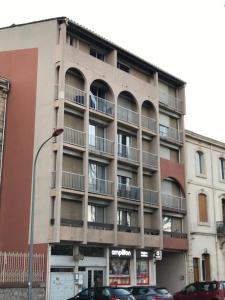 an apartment building on the corner of a street at LE MONICA in Narbonne