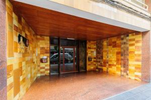 an entrance to a building with yellow and brown tiles at Carrer Sevilla in Tarragona