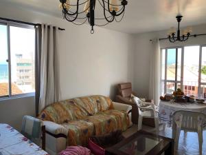 a living room with a couch and a table at Aconchegante apartamento a beira mar barra velha in Barra Velha +15 photos