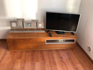 a flat screen tv sitting on top of a wooden entertainment center at APARTAMENT TUCAMP nº6275 in Encamp