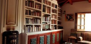 a book shelf filled with books in a room at Posada El Prado in Salta