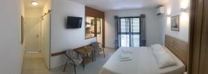 a room with a bed and a table and chairs at Apartment NECA in Lovište