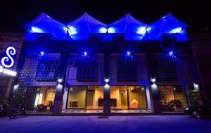 a building with blue lights on it at night at Chalong Sea Breeze in Chalong