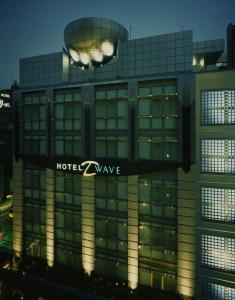 a building with a hotel wave sign on it at HOTEL D-WAVE Shinjuku（Adult Only) in Tokyo