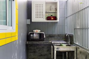 a kitchen with a sink and a microwave at Greenery Resort Koh Tao in Ko Tao